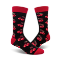 Pair of black crew socks with a repeating pattern of red cherries and green stems. Red cuffs.