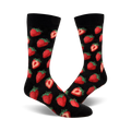 A pair of black crew socks with a red strawberry pattern. The strawberries are realistically rendered and scattered across the socks.