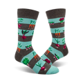 Pair of crew socks with teal and gray stripes.  The socks are adorned with colorful images of carrots, beets, radishes, and other garden vegetables.