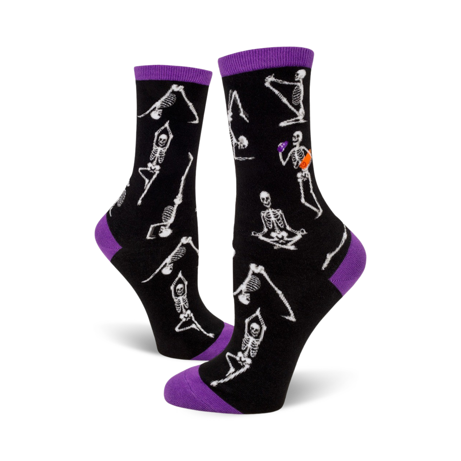 A pair of black crew socks with purple cuffs.  The socks are adorned with a pattern of white skeletons performing yoga poses.
