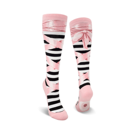 black and white striped socks with pink ballet slipper on bottom of foot. pink ribbons on black background on leg. pink top with two black stripes. womens high ballet slippers.  