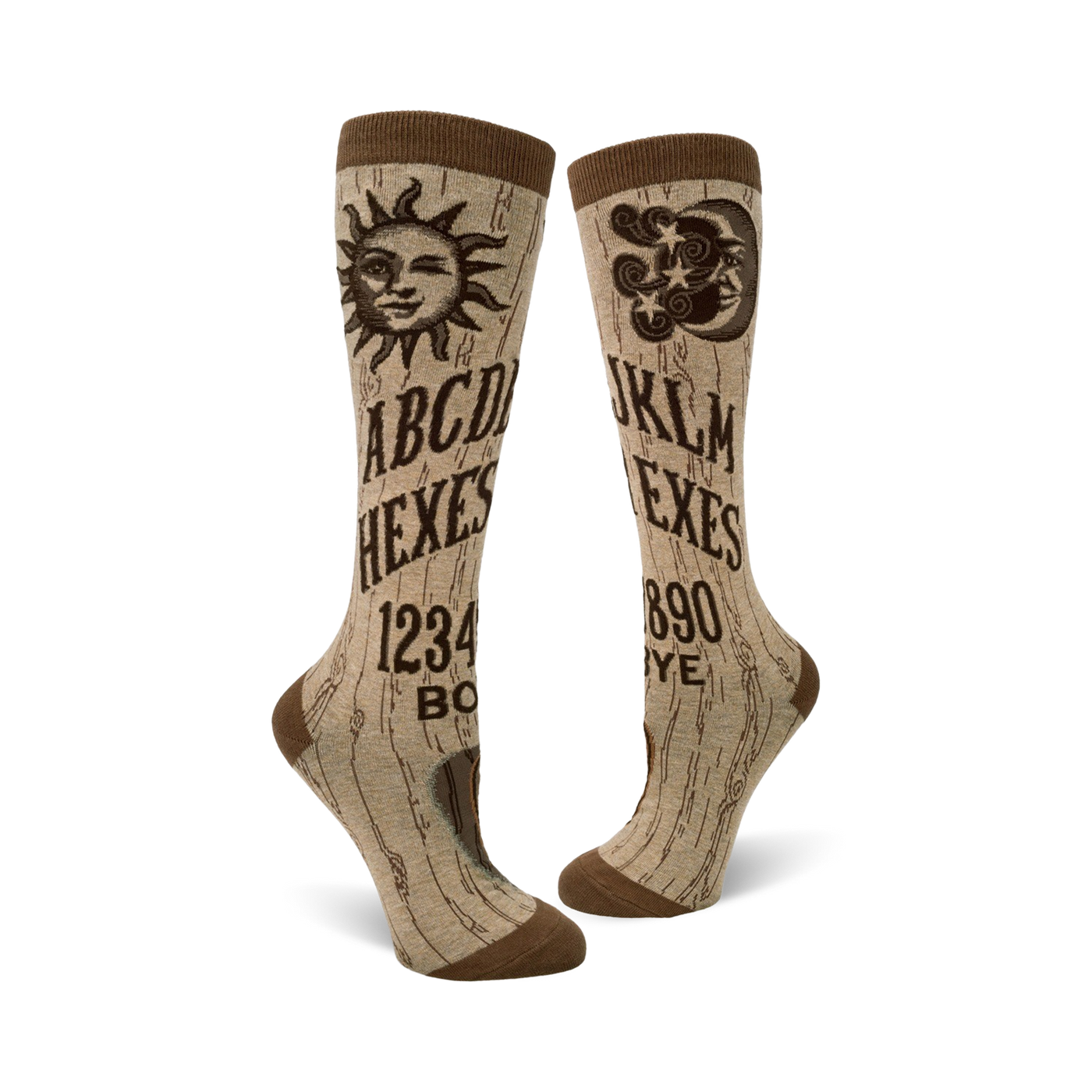A pair of beige knee-high socks with a brown Ouija board design. The socks feature a sun, moon, and alphabet graphics.