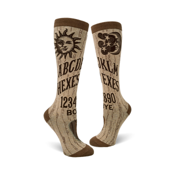 knee high brown halloween socks with planchette game board print. a-d 1-4 and j-m 5-9 letters and "hexes" and "exes" print.    