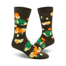 crew socks with a gourd and pumpkin pattern in shades of orange, yellow, and green on a dark background. perfect for fall.  