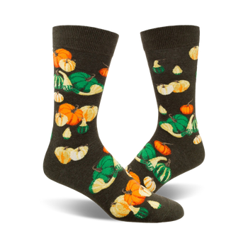 crew socks with a gourd and pumpkin pattern in shades of orange, yellow, and green on a dark background. perfect for fall.  