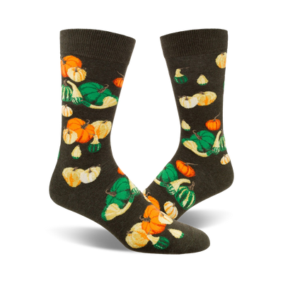 crew socks with a gourd and pumpkin pattern in shades of orange, yellow, and green on a dark background. perfect for fall.  