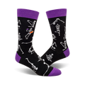 Black crew socks with purple cuffs.  The design features white skeletons performing different yoga poses.  A fun and spooky design!
