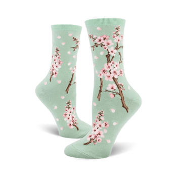 light green crew socks with pink and white cherry blossom pattern, light green toe and heel, perfect for women's fashion.  