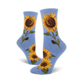 A pair of blue crew socks with sunflower designs shown on a white background.