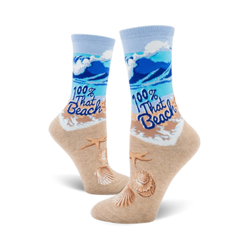  light blue crew socks with blue waves, starfish and seashells, and tan shore printed on fabric. caption "100% that beach."  
