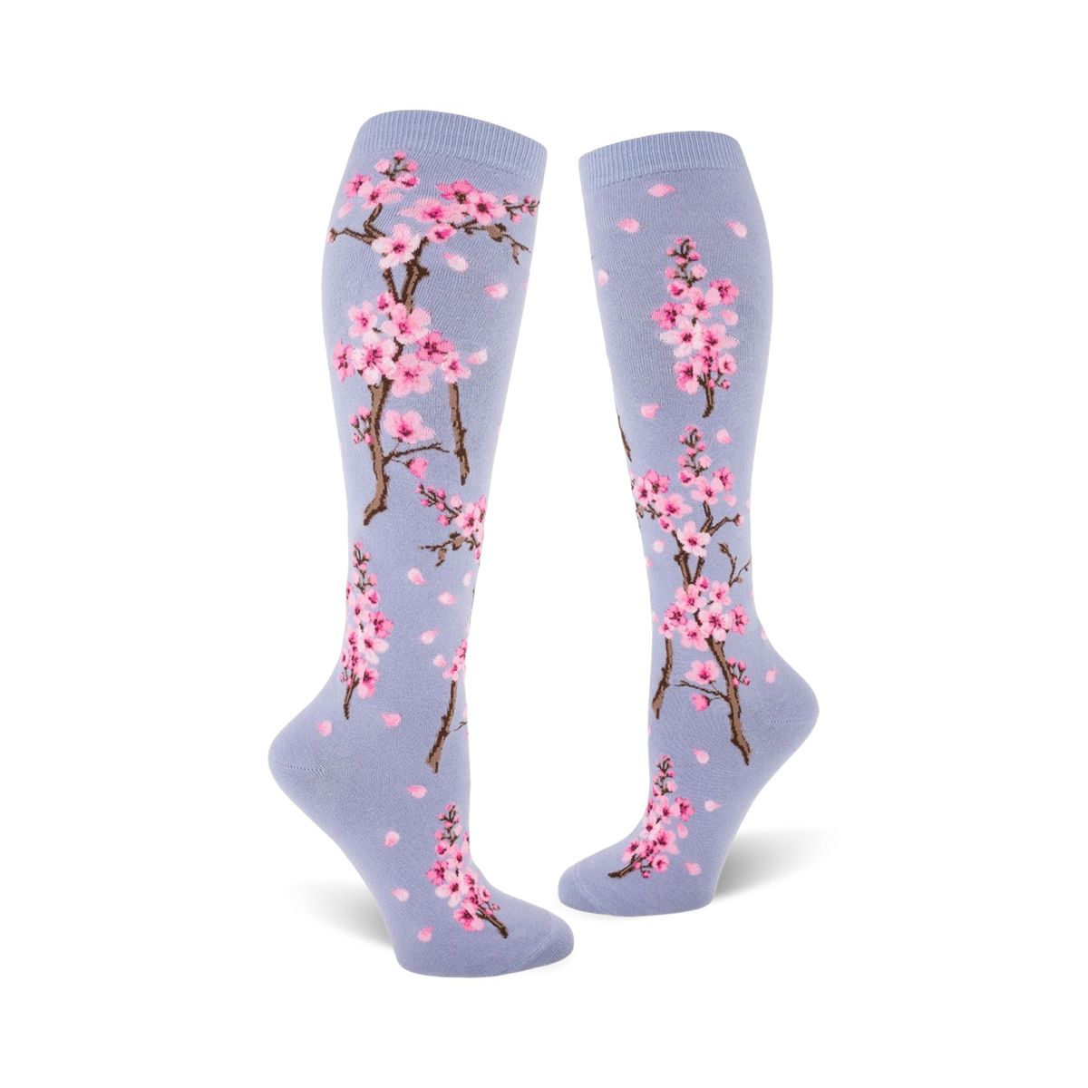 Lifestyle shot showing the blue Cherry Blossom knee-high socks on a model's legs.
