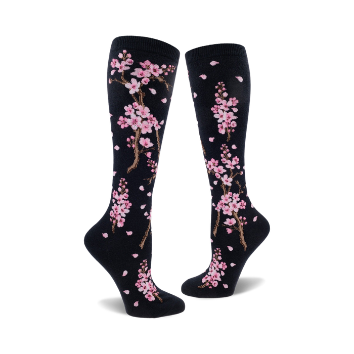 black knee-high women's socks with pink cherry blossom and falling petal design.  