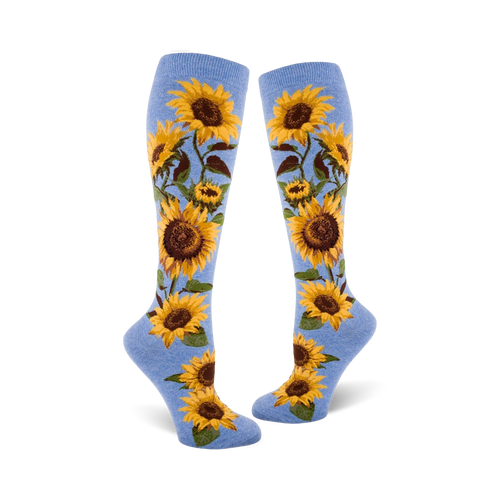 Lifestyle shot showing a person wearing the blue sunflower knee-high socks. They're styled with jeans and sneakers.