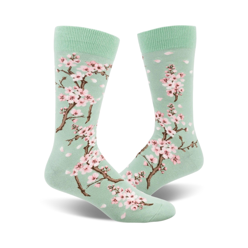 Pair of crew socks, mint green with pink cherry blossoms and petals.  Beautiful floral print.