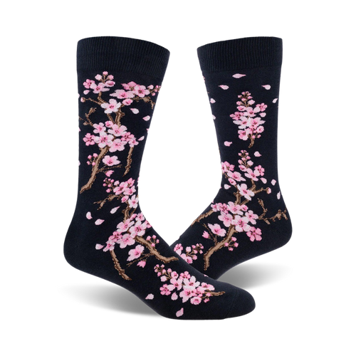 Close-up view of a pair of navy blue crew socks with a delicate pink cherry blossom pattern.