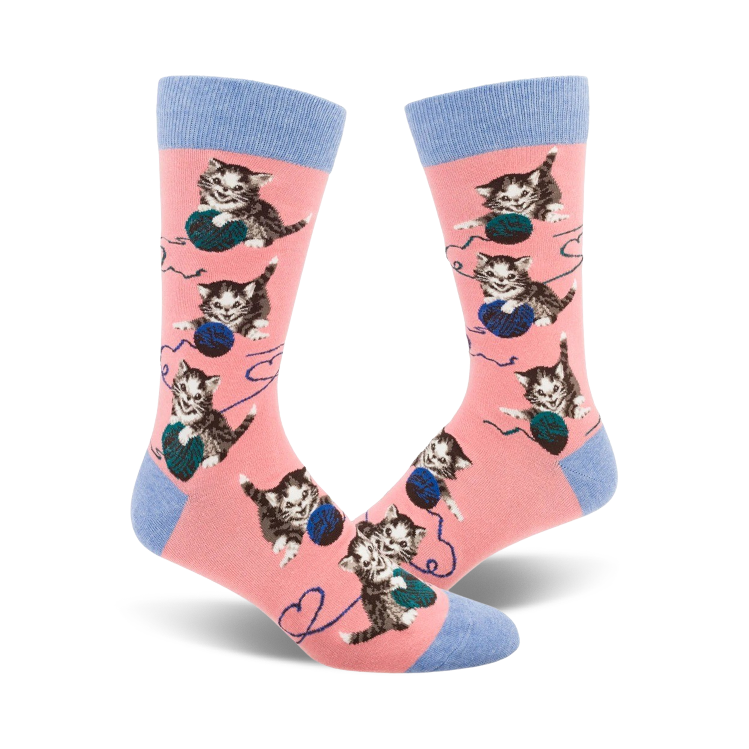 Pair of pink crew socks featuring repeated images of kittens batting at balls of yarn.  Socks have light blue cuffs.
