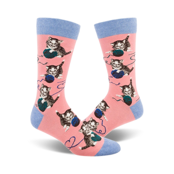 pink crew socks with playful kittens frolicking in blue yarn pattern.   