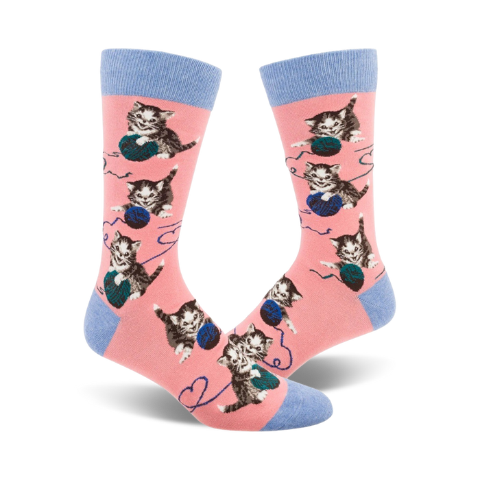 pink crew socks with playful kittens frolicking in blue yarn pattern.    }}