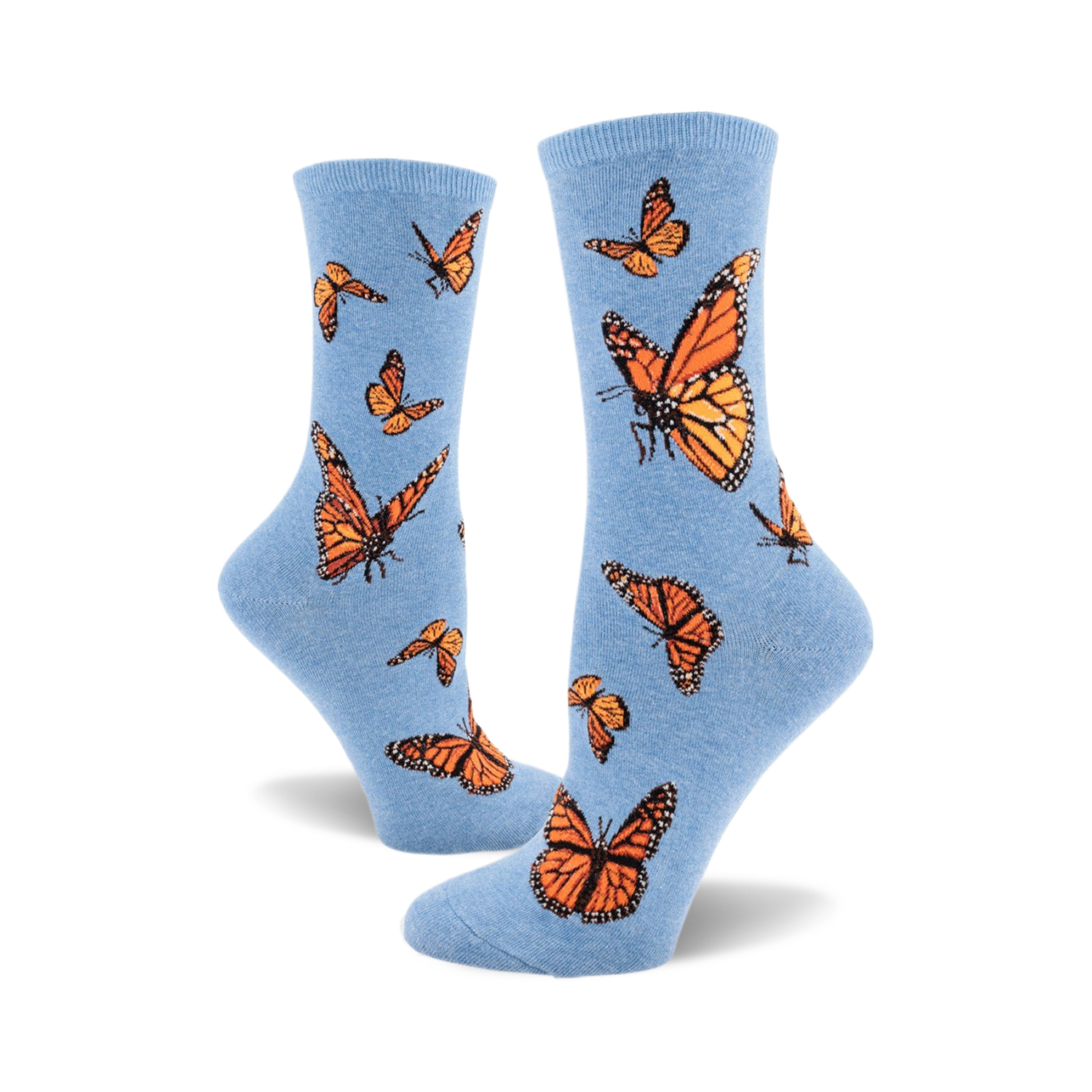 A pair of light blue crew socks adorned with a pattern of orange monarch butterflies. The socks are shown from the side, one sock partially obscuring the other.