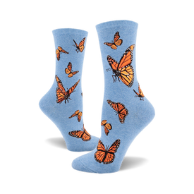 these are blue socks with a pattern of monarch butterflies. the butterflies are orange and black with white markings on their wings.