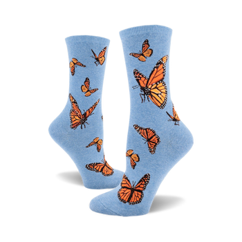 these are blue socks with a pattern of monarch butterflies. the butterflies are orange and black with white markings on their wings.
