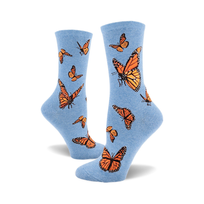 these are blue socks with a pattern of monarch butterflies. the butterflies are orange and black with white markings on their wings.