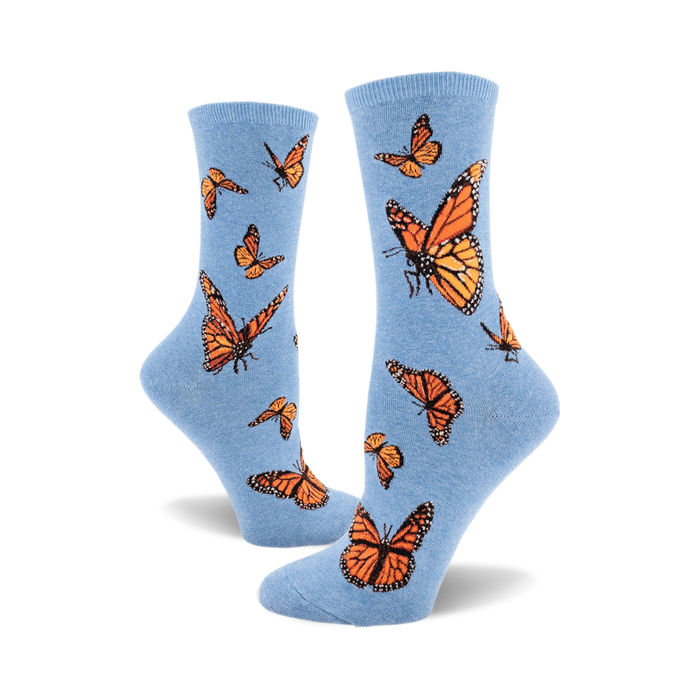 these are blue socks with a pattern of monarch butterflies. the butterflies are orange and black with white markings on their wings. }}