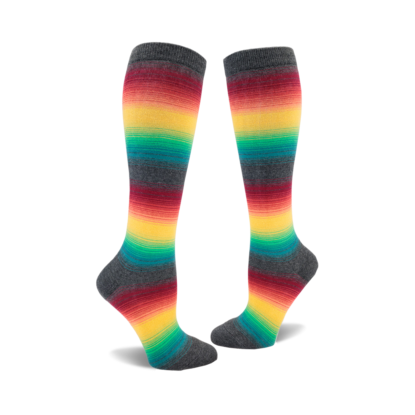 Pair of knee-high socks with horizontal rainbow stripes on a charcoal grey background.  The colors include red, orange, yellow, green, and teal.