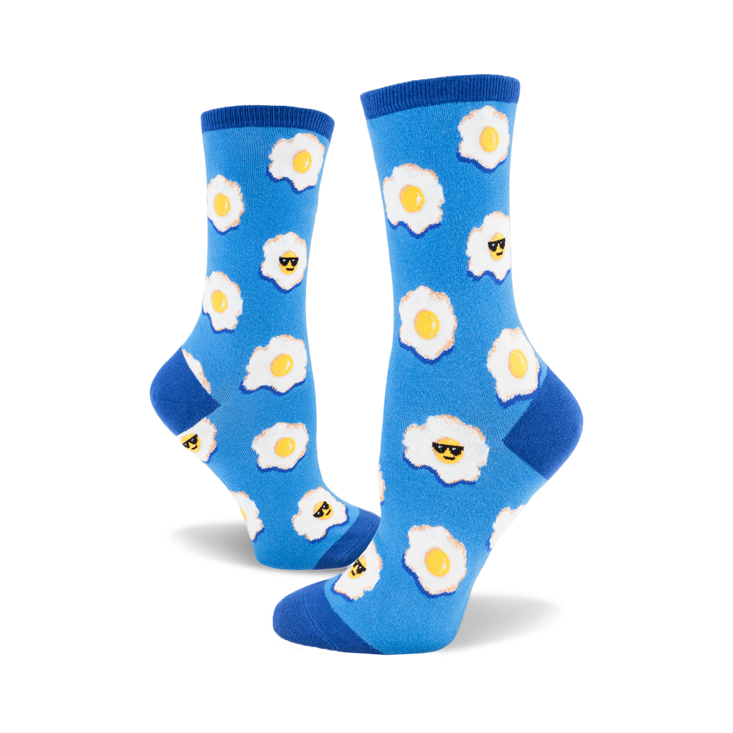 A pair of women's crew socks in blue with a pattern of fried eggs wearing sunglasses. Yellow yolks and white egg whites stand out on the vibrant blue background.