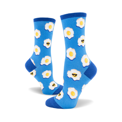 side view of a pair of blue socks with a fried egg pattern. each egg has a smiley face wearing sunglasses.