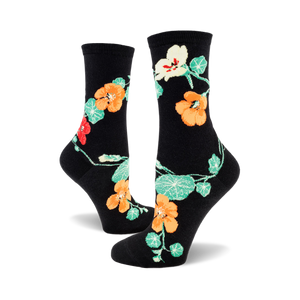 pair of black crew socks with orange and green nasturtium flowers.