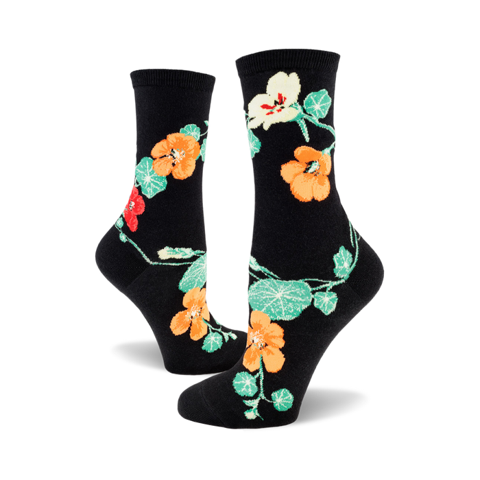 pair of black crew socks with orange and green nasturtium flowers.