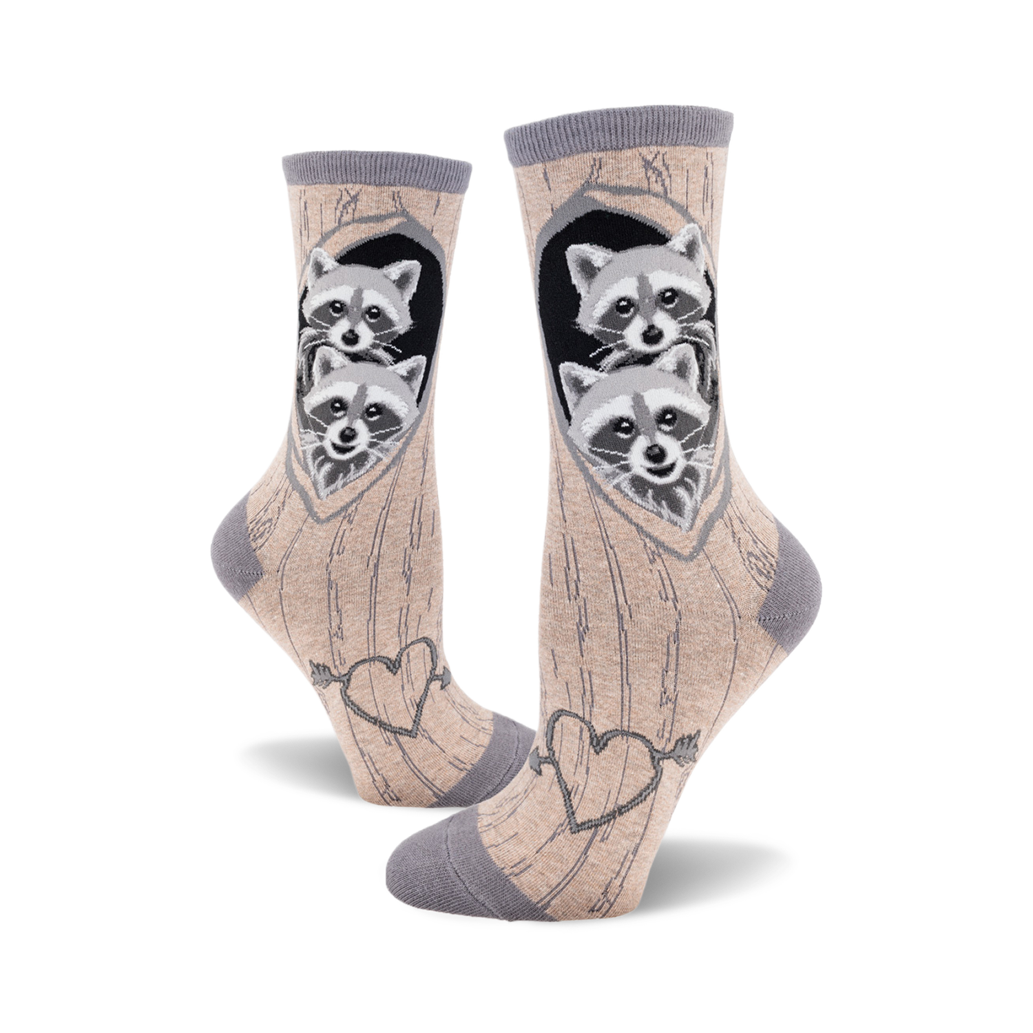 Crew socks in beige and grey featuring two raccoons peeking from a tree heart, with an arrow-pierced heart design at the bottom.