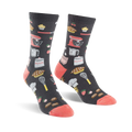 Pair of crew socks in dark gray with coral toes and heels.  The socks are adorned with illustrations of kitchen tools, baked goods, and strawberries.