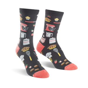 Pair of crew socks in dark gray with coral toes and heels.  The socks are adorned with illustrations of kitchen tools, baked goods, and strawberries.