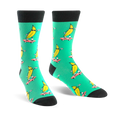 Crew socks in teal with a repeated pattern of yellow bananas skateboarding. Bananas wear sunglasses.