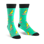 Crew socks in teal with a repeated pattern of yellow bananas skateboarding. Bananas wear sunglasses.