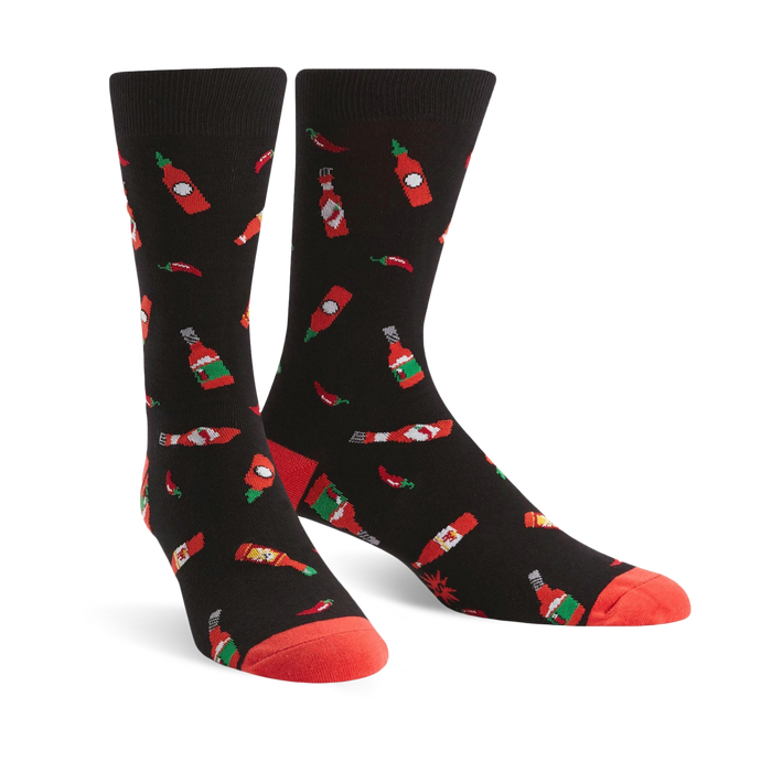 black crew socks for men with red chili pepper and hot sauce bottle pattern.   }}