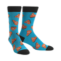 Pair of teal crew socks featuring a pattern of cartoonish orange steaks. Black cuffs and toes.
