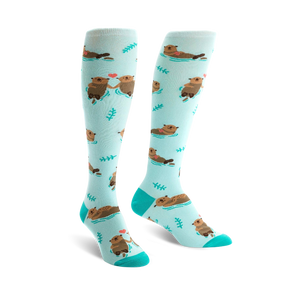 Pair of teal knee-high socks with a pattern of brown otters holding hands and small hearts.  Simple leaf designs are also scattered on the socks.