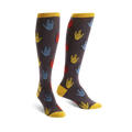 A pair of knee-high socks with a dark gray background and a repeating pattern of colorful Vulcan salutes in red, blue, and yellow.
