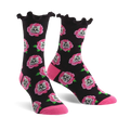 Crew socks with a black background, pink roses, and cat faces. The socks have a ruffled top edge and pink heel and toe.