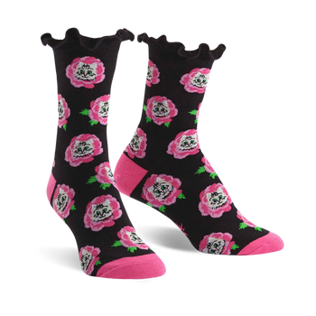 Crew socks with a black background, pink roses, and cat faces. The socks have a ruffled top edge and pink heel and toe.