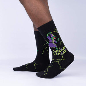 A pair of black socks with a green and yellow design of a wizard and a lizard on each sock. The text 