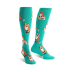 Pair of teal knee-high socks with a playful pattern of orange foxes wearing boxes on their heads. 