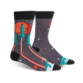 A pair of crew socks with a dark grey background, orange and teal rockets launching from a planet, and orange laser beams.
