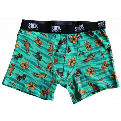 Teal men's boxer briefs with a tropical print. Design includes tiki masks, hula dancers, palm trees, and hibiscus flowers.