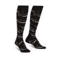 Pair of black knee-high socks with a repeating pattern of light grey whales and stars. The socks glow in the dark.