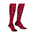 Pair of red knee-high socks with black dinosaurs drinking wine bottles. Fun and quirky design.