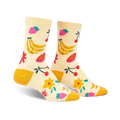 Cream crew socks with a playful fruit design. Bananas, strawberries, cherries, and flowers in yellow, pink, and red are featured on a light yellow background.